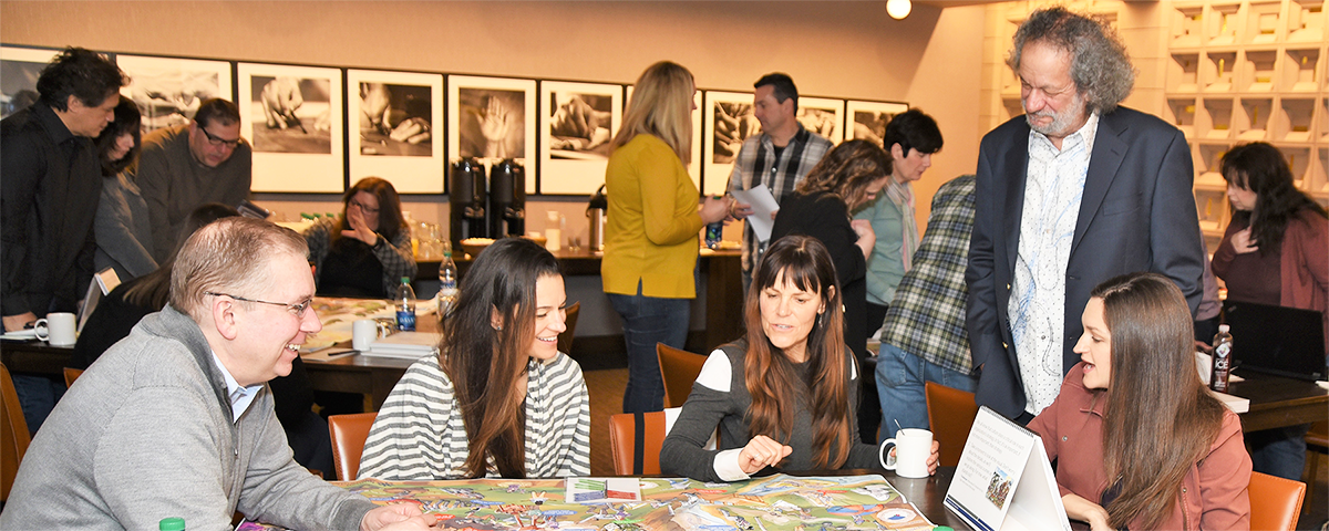 Group of People Conversing at a Table During an Event