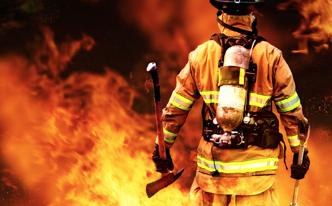 Firefighter Walking Towards a Fire